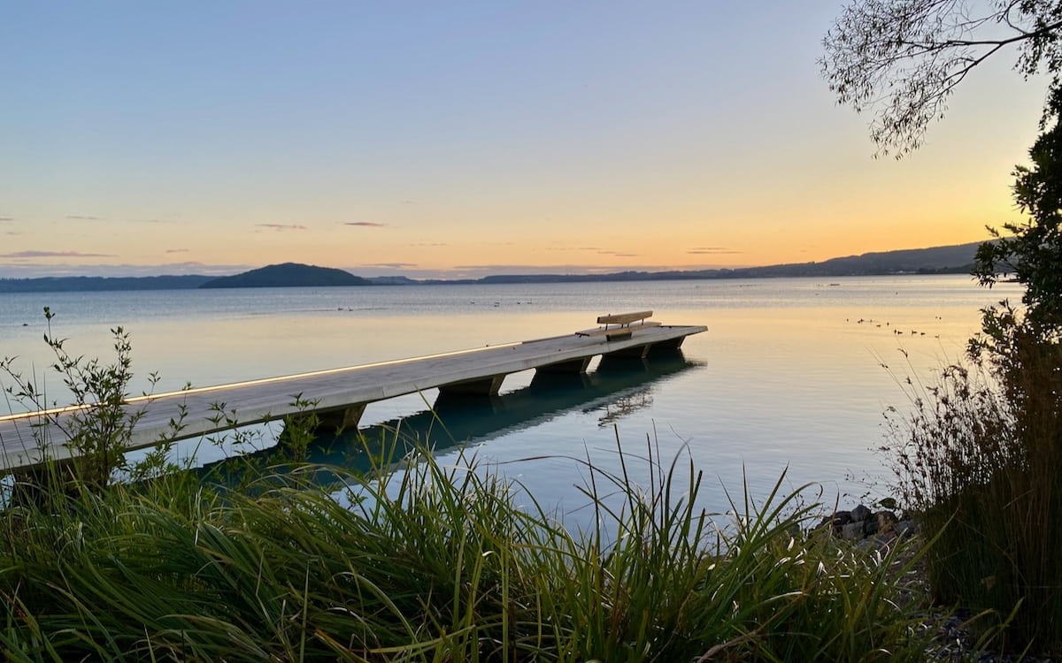 Reflection seat at sunrise over Lake Rotorua.