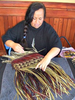 Weaver working on a Kete (basket)