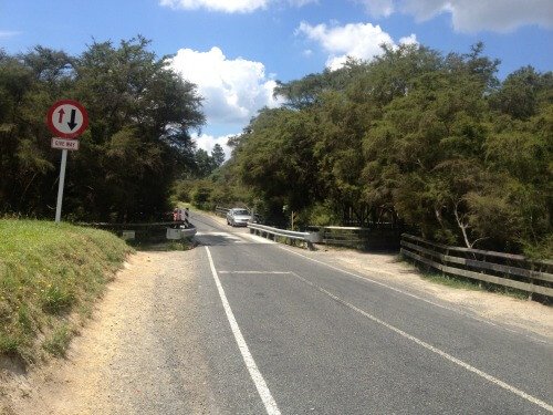 The Waiotapu Bridge under which the hot stream flows from the left to join the cold stream on the right-hand side.