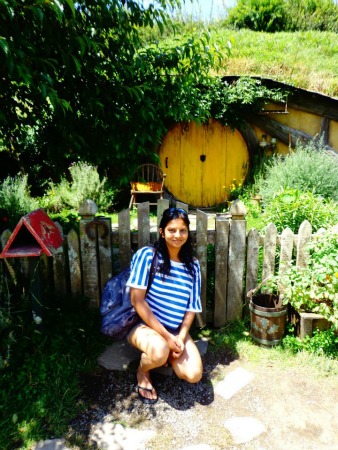Sonal outside a hobbit hole at Hobbiton, NZ